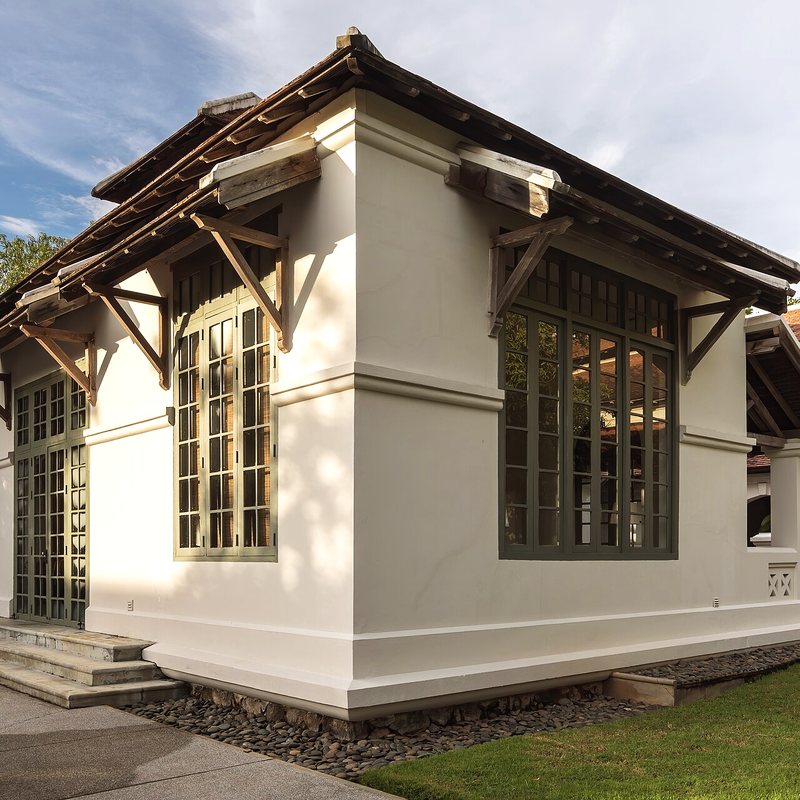 Façade blanche de la maison et sa galerie
